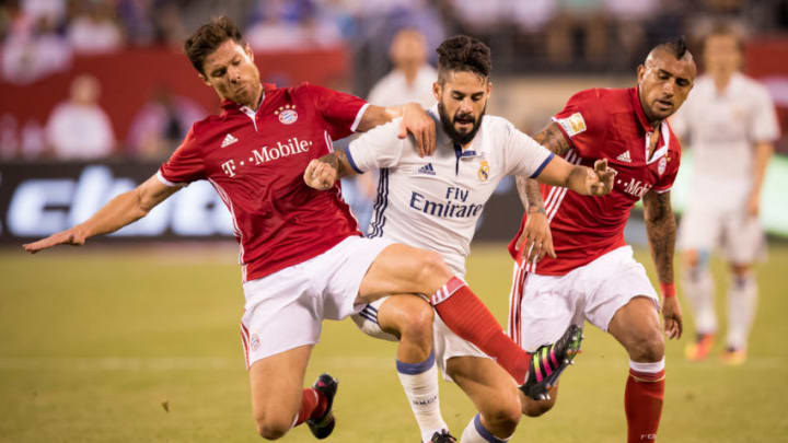 EAST RUTHERFORD, NJ - August 03, 2016 Real Madrid Midfielder Isco (22) barrels his way through FC Bayern Munich Defender Xabi Alonso (14) and Midfielder Arturo Vidal (23) during the International Champions Cup match between FC Bayern Munich vs Real Madrid, Soccer, 2016 on August 03, 2016 at Met Life Stadium in East Rutherford, NJ, USA . Real Madrid won the match with a score of 1 to 0. Photo by Ira L. Black/Corbis via Getty Images