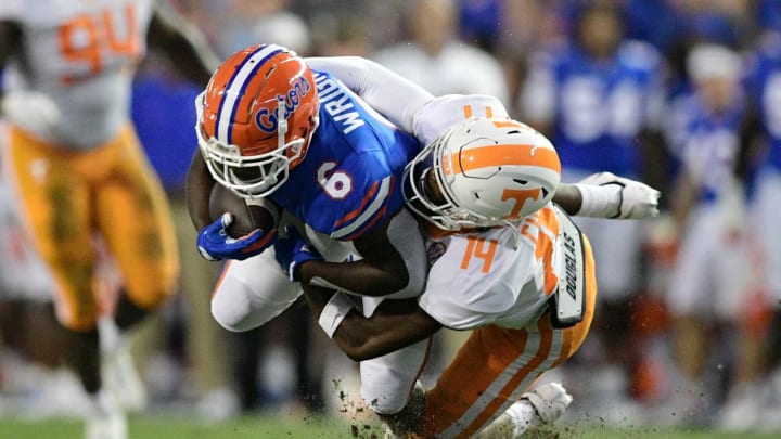 Tennessee defensive back Christian Charles (14) tackles Florida running back Nay’Quan Wright (6) during the first quarter of an NCAA football game against Florida at Ben Hill Griffin Stadium in Gainesville, Florida on Saturday, Sept. 25, 2021.Tennflorida0925 0802