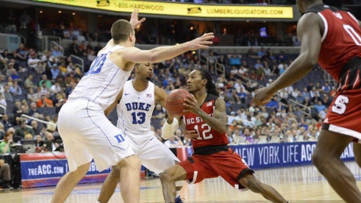 Mar 9, 2016; Washington, DC, USA; North Carolina State Wolfpack guard Anthony Barber (12) drives to the basket as Duke Blue Devils center Marshall Plumlee (40) and guard Matt Jones (13) defends in the second half during day two of the ACC conference tournament at Verizon Center. Duke Blue Devils defeated North Carolina State Wolfpack 92-89. Mandatory Credit: Tommy Gilligan-USA TODAY Sports