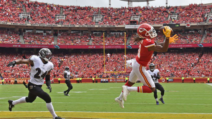 KANSAS CITY, MO - SEPTEMBER 22: Wide receiver Demarcus Robinson #11 of the Kansas City Chiefs catches a touchdown pass against cornerback Brandon Carr #24 of the Baltimore Ravens during the first half at Arrowhead Stadium on September 22, 2019 in Kansas City, Missouri. (Photo by Peter Aiken/Getty Images)