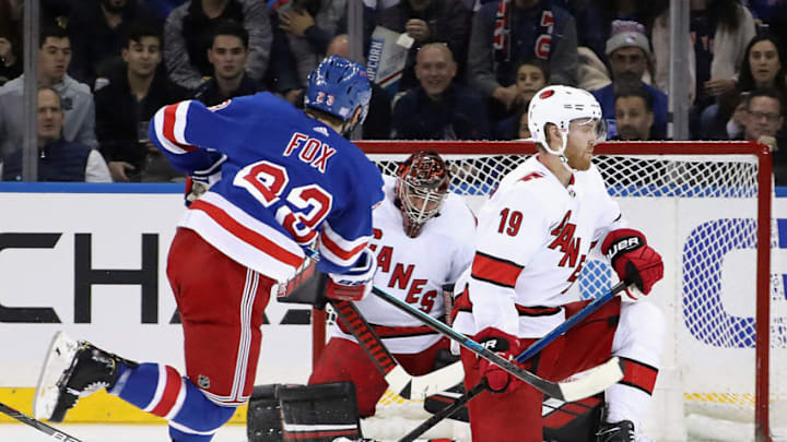 NEW YORK, NEW YORK - NOVEMBER 27: Petr Mrazek #34 and Dougie Hamilton #19 of the Carolina Hurricanes looks to block a shot by Adam Fox #23 of the New York Rangers during the first period at Madison Square Garden on November 27, 2019 in New York City. (Photo by Bruce Bennett/Getty Images)