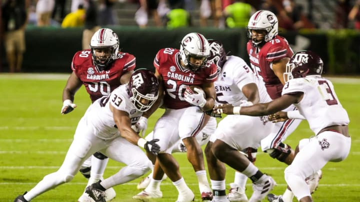 Nov 7, 2020; Columbia, South Carolina, USA; South Carolina Gamecocks running back Kevin Harris (20) is wrapped by Texas A&M Aggies linebacker Aaron Hansford (33) in the second quarter at Williams-Brice Stadium. Mandatory Credit: Jeff Blake-USA TODAY Sports