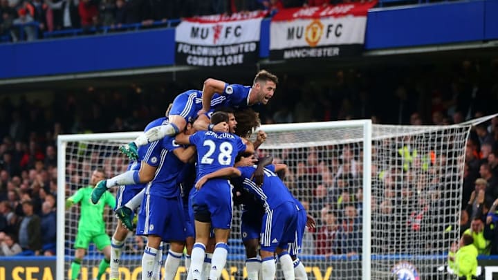 LONDON, ENGLAND - OCTOBER 23: Gary Cahill of Chelsea jumps on tops as N'golo Kante of Chelsea celebrates with his team mates after he scores to make it 4-0 during the Premier League match between Chelsea and Manchester United at Stamford Bridge on October 23, 2016 in London, England. (Photo by Catherine Ivill - AMA/Getty Images)