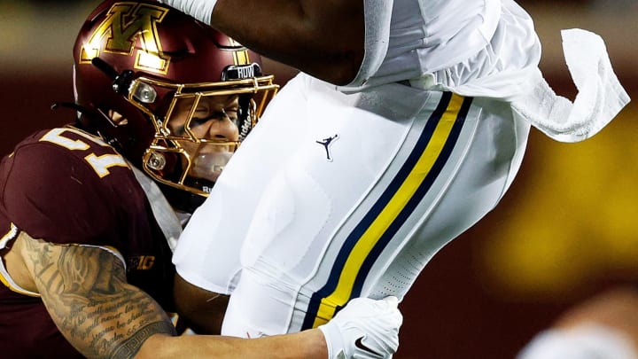 MINNEAPOLIS, MINNESOTA – OCTOBER 07: Kalel Mullings #20 of the Michigan Wolverines is tackled by Craig McDonald #21 of the Minnesota Golden Gophers in the second half at Huntington Bank Stadium on October 07, 2023 in Minneapolis, Minnesota. The Wolverines defeated the Golden Gophers 52-10. (Photo by David Berding/Getty Images)