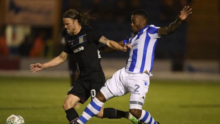 COLCHESTER, ENGLAND - AUGUST 09: Birkir Bjarnason of Aston Villa is challenged by Ritchie De Laet of Colchester during the Carabao Cup First Round match between Colchester United and Aston Villa at Colchester Community Stadium on August 9, 2017 in Colchester, England. (Photo by Mike Hewitt/Getty Images)