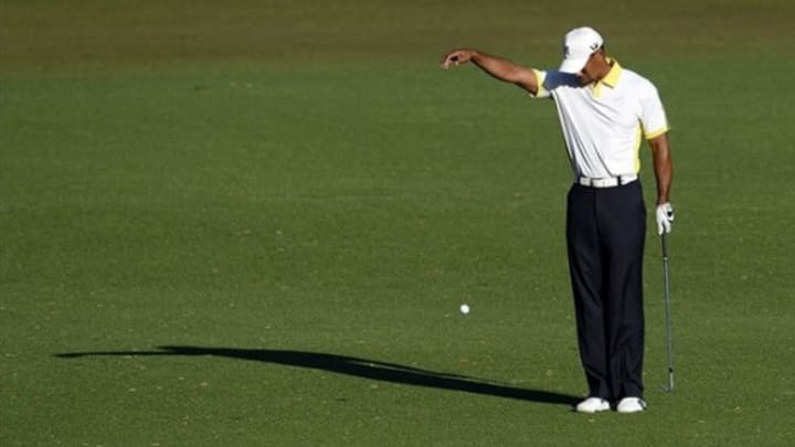 Apr 12, 2013; Augusta, GA, USA; Tiger Woods takes a drop on the 15th hole during the second round of the 2013 The Masters golf tournament at Augusta National Golf Club. Mandatory Credit: Michael Madrid-USA TODAY Sports