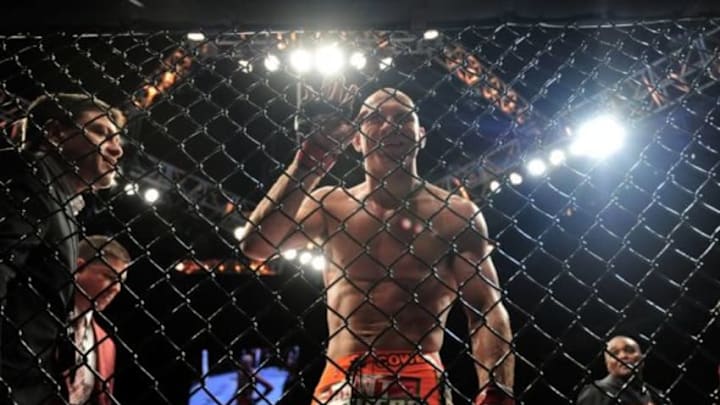 May 23, 2015; Las Vegas, NV, USA; Donald Cerrone (red gloves) reacts to knocking out and breaking the jaw of John Makdessi (not pictured) during their lightweight bout during UFC 187 at MGM Grand Garden Arena. Cerrone won via second round TKO. Mandatory Credit: Joe Camporeale-USA TODAY Sports