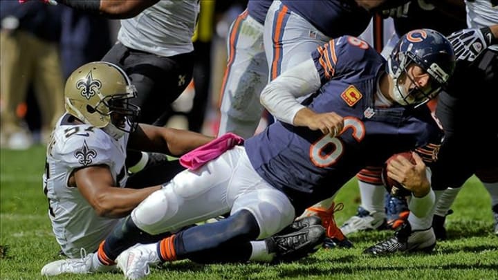 Oct 6, 2013; Chicago, IL, USA; Chicago Bears quarterback Jay Cutler (6) is sacked by New Orleans Saints outside linebacker David Hawthorne (57) during the first quarter at Soldier Field. Mandatory Credit: Matt Marton-USA TODAY Sports