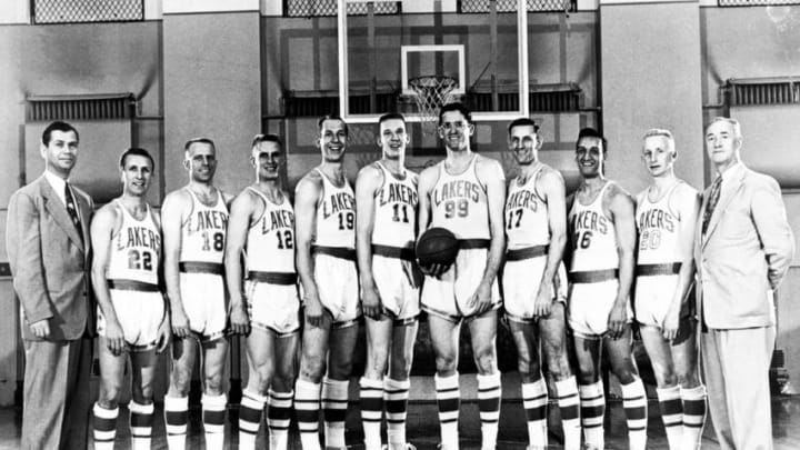 MINNEAPOLIS - 1953: The World Champions of basketball Minneapolis Lakers pose for a team portrait (L-R): Head Coach John Kundla, Slater Martin, Frank Saul, Jim Holstein, Vern Mikkelsen, Lew Hitch, George Mikan, Jim Pollard, Bob Harrison, Whitey Skoog, Assisstant coach Dave McMillan. in Minneapolis, Minnesota in 1953. NOTE TO USER: User expressly acknowledges and agrees that, by downloading and or using this photograph, User is consenting to the terms and conditions of the Getty Images License Agreement. Mandatory copyright notice: Copyright NBAE 2002 (Photo by NBAP/ NBAE/ Getty Images)
