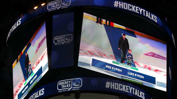 VANCOUVER, BC - JANUARY 16: The Vancouver Canucks celebrate HockeyTalks, an NHL mental health initiative and Wes Rypien and Luke Rypien partake in a ceremonial puck drop during their NHL game against the Arizona Coyotes at Rogers Arena on January 16, 2020 in Vancouver, British Columbia, Canada.(Photo by Devin Manky/Icon Sportswire via Getty Images)