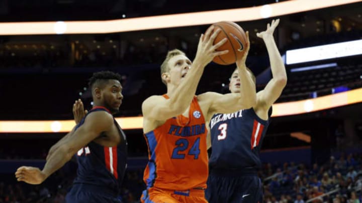 Nov 21, 2016; Tampa, FL, USA; Florida Gators guard Canyon Barry (24) shoots a layup over Belmont Bruins guard Dylan Windler (3) during the second half at Amalie Arena. Florida defeated Belmont 78-61. Mandatory Credit: Kim Klement-USA TODAY Sports
