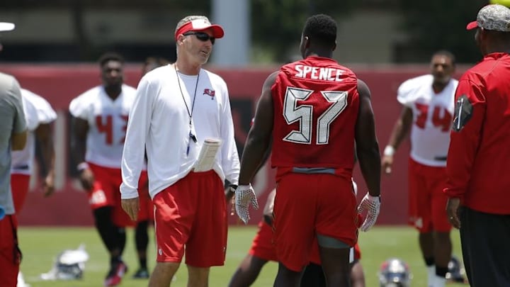 Jun 14, 2016; Tampa Bay, FL, USA; Tampa Bay Buccaneers head coach Dirk Koetter (left) and defensive end Noah Spence (57) talk as they work out during mini camp at One Buccaneer Place. Mandatory Credit: Kim Klement-USA TODAY Sports