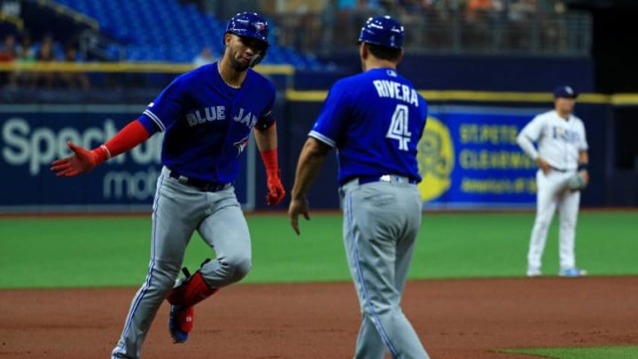 Lourdes Gurriel Jr. #13 of the Toronto Blue Jays is congratulated after hitting a two run home run in the first inning during a game against the Tampa Bay Rays at Tropicana Field. (Photo by Mike Ehrmann/Getty Images)