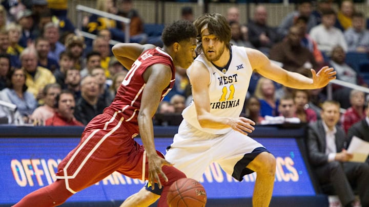 Jan 18, 2017; Morgantown, WV, USA; West Virginia Mountaineers forward Nathan Adrian (11) guards Oklahoma Sooners guard Kameron McGusty (20) during the second half at WVU Coliseum. Mandatory Credit: Ben Queen-USA TODAY Sports