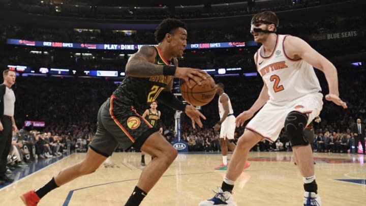 NEW YORK, NEW YORK - DECEMBER 21: John Collins #20 of the Atlanta Hawks dribbles against Luke Kornet #2 of the New York Knicks during the second quarter of the game at Madison Square Garden on December 21, 2018 in New York City. NOTE TO USER: User expressly acknowledges and agrees that, by downloading and or using this photograph, User is consenting to the terms and conditions of the Getty Images License Agreement. (Photo by Sarah Stier/Getty Images)