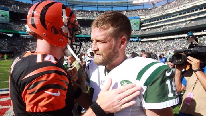 Sep 11, 2016; East Rutherford, NJ, USA; Cincinnati Bengals quarterback Andy Dalton (14) and New York Jets quarterback Ryan Fitzpatrick (14) meet at midfield after a game at MetLife Stadium. Mandatory Credit: Brad Penner-USA TODAY Sports