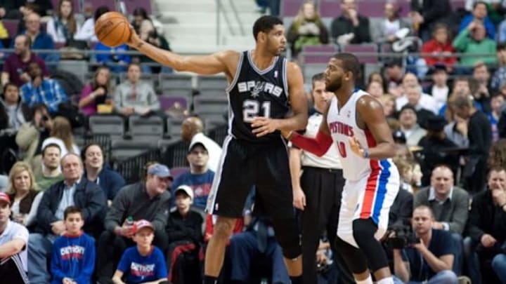 Feb 10, 2014; Auburn Hills, MI, USA; Detroit Pistons power forward Greg Monroe (10) guards San Antonio Spurs power forward Tim Duncan (21) during the first quarter at The Palace of Auburn Hills. Mandatory Credit: Tim Fuller-USA TODAY Sports