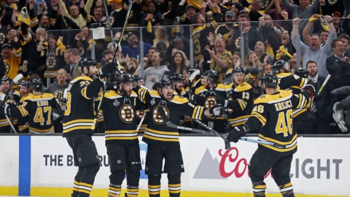 BOSTON, MA - MAY 27: From left, Bruins Zdeno Chara, Patrice Bergeron, Brad Marchand and David Krejci celebrate, as does the players on the bench in the background as well as the crowd following Marchand's empty net goal that wrapped up Boston's victory. The Boston Bruins host the St. Louis Blues in Game One of the 2019 Stanley Cup Finals at TD Garden on May 27, 2019. (Photo by Jim Davis/The Boston Globe via Getty Images)