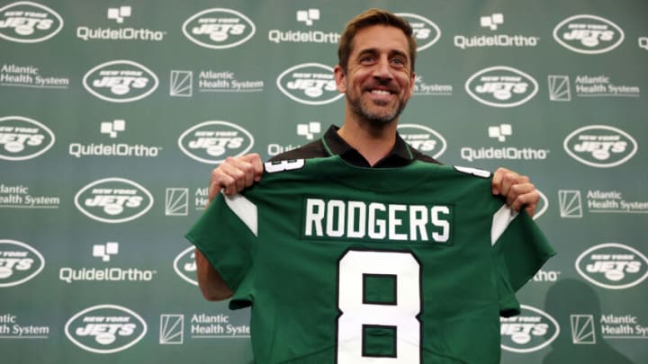 New York Jets quarterback Aaron Rodgers poses with a jersey during an introductory press conference at Atlantic Health Jets Training Center on April 26, 2023 in Florham Park, New Jersey. (Photo by Elsa/Getty Images)