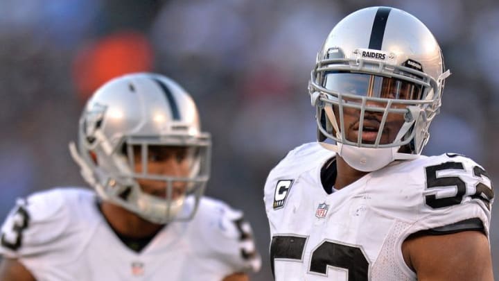 Dec 18, 2016; San Diego, CA, USA; Oakland Raiders defensive end Khalil Mack (52) and outside linebacker Malcolm Smith (53) look on during the fourth quarter against the San Diego Chargers at Qualcomm Stadium. Mandatory Credit: Jake Roth-USA TODAY Sports