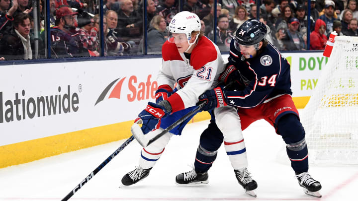 COLUMBUS, OHIO – NOVEMBER 17: Kaiden Guhle #21 of the Montreal Canadiens controls the puck against Cole Sillinger #34 of the Columbus Blue Jackets during the second period at Nationwide Arena on November 17, 2022 in Columbus, Ohio. (Photo by Emilee Chinn/Getty Images)