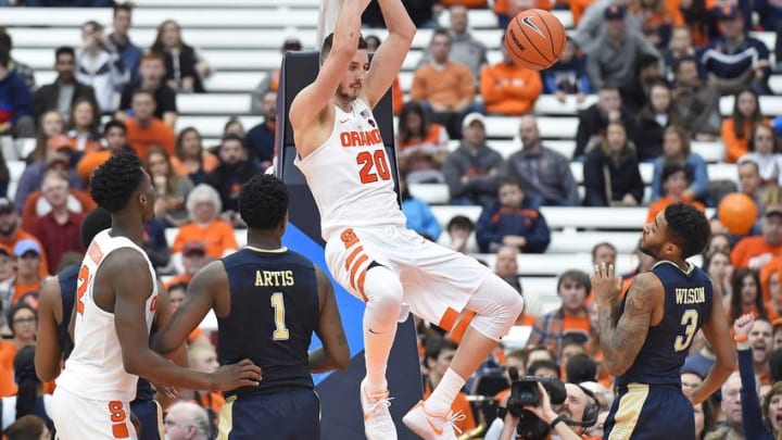 Jan 7, 2017; Syracuse, NY, USA; Syracuse Orange forward Tyler Lydon (20) dunks the ball between Pittsburgh Panthers forward Jamel Artis (1) and guard Damon Wilson (3) during the second half at the Carrier Dome. Syracuse won 77-66. Mandatory Credit: Rich Barnes-USA TODAY Sports