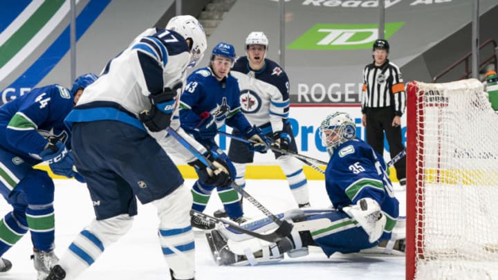 VANCOUVER, BC - MARCH 22: Adam Lowry #17 of the Winnipeg Jets scores a goal past goalie Thatcher Demko #35 of the Vancouver Canucks during the third period of NHL action at Rogers Arena on March 22, 2021 in Vancouver, Canada. (Photo by Rich Lam/Getty Images)