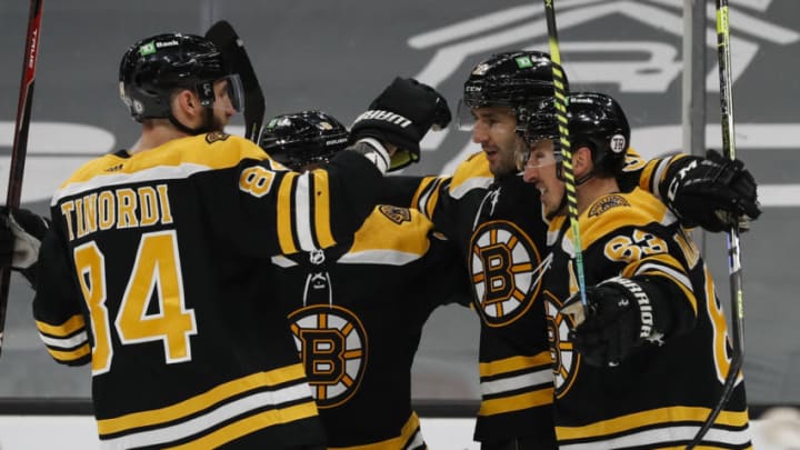 Apr 18, 2021; Boston, Massachusetts, USA; Boston Bruins center Patrice Bergeron (37) celebrates his shorthanded goal with center Brad Marchand (63) and defenseman Jarred Tinordi (84) during the first period against the Washington Capitals at TD Garden. Mandatory Credit: Winslow Townson-USA TODAY Sports