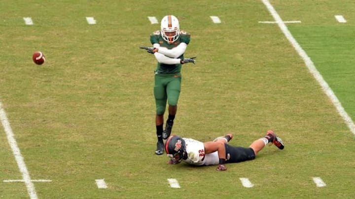 Sep 13, 2014; Miami Gardens, FL, USA; Arkansas State Red Wolves tight end Warren Leapheart (82) has his pass broken up by Miami Hurricanes defensive back Corn Elder (29) during the first half at Sun Life Stadium. Miami won 41-20. Mandatory Credit: Steve Mitchell-USA TODAY Sports