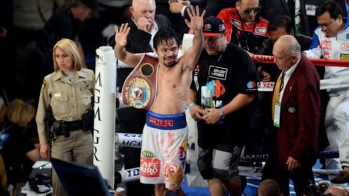 Apr 12, 2014; Las Vegas, NV, USA; Manny Pacquiao celebrates after defeating Tomothy Bradley Jr. (not pictured in their WBO World Welterweight Title bout at MGM Grand Garden Arena. Pacquiao won via unanimous decision. Mandatory Credit: Joe Camporeale-USA TODAY Sports