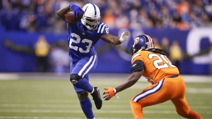 Frank Gore #23 of the Indianapolis Colts pushes off a tackle from Jamal Carter #20 of the Denver Broncos during the second half at Lucas Oil Stadium on December 14, 2017 in Indianapolis, Indiana. (Photo by Joe Robbins/Getty Images)