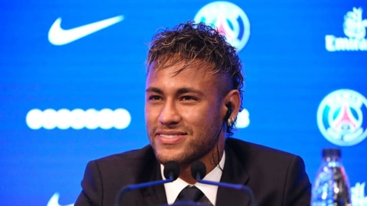 Brazilian superstar Neymar listens during a press conference at the Parc des Princes stadium on August 4, 2017 in Paris after agreeing a five-year contract following his world record 222 million euro ($260 million) transfer from Barcelona to Paris Saint-Germain.Paris Saint-Germain have signed Brazilian forward Neymar from Barcelona for a world-record transfer fee of 222 million euros (around $264 million), more than doubling the previous record. Neymar said he came to Paris Saint-Germain for a "bigger challenge" in his first public comments since arriving in the French capital. / AFP PHOTO / Lionel BONAVENTURE (Photo credit should read LIONEL BONAVENTURE/AFP via Getty Images)