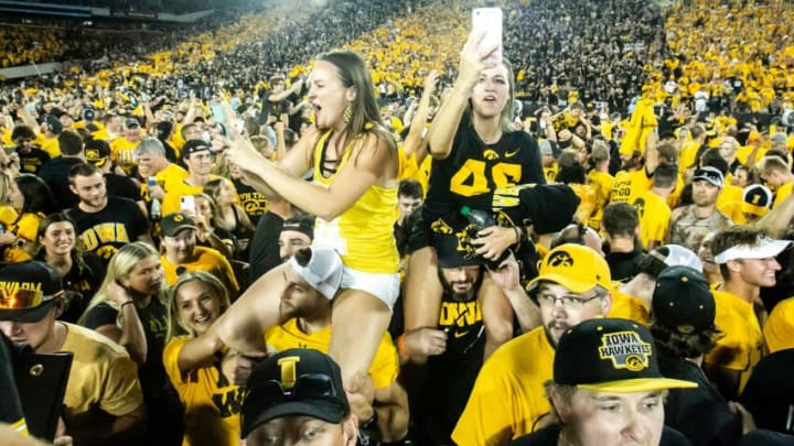Iowa Hawkeyes fans celebrate while storming the field after a NCAA Big Ten Conference football game against Penn State, Saturday, Oct. 9, 2021, at Kinnick Stadium in Iowa City, Iowa. Iowa beat Penn State, 23-20.211009 Penn St Iowa Fb 083 Jpg