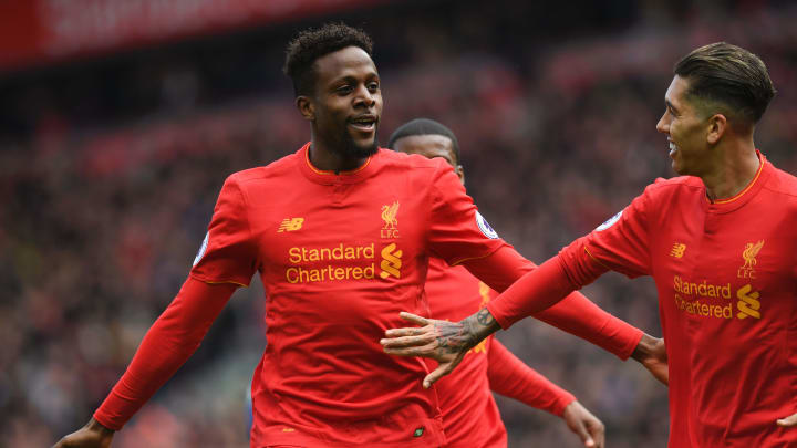 Divock Origi celebrates with  Roberto Firmino after scoring their third goal during the Premier League match between Liverpool and Everton at Anfield on April 1, 2017.  (Photo credit should read PAUL ELLIS/AFP/Getty Images)