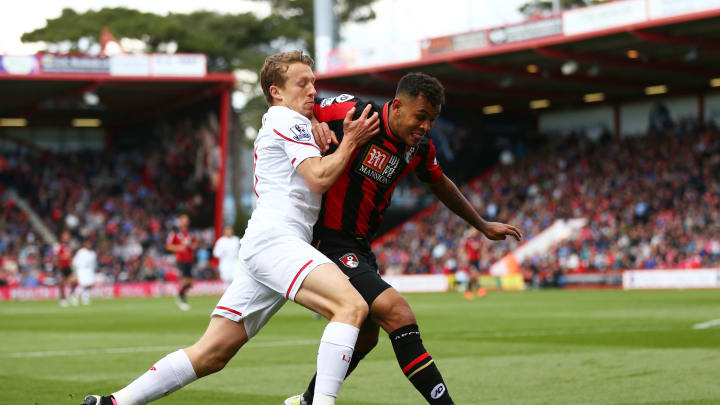 BOURNEMOUTH, ENGLAND – APRIL 17: Callum Wilson of Bournemouth holds off pressure from Lucas Leiva of Liverpool during the Barclays Premier League match between A.F.C. Bournemouth and Liverpool at the Vitality Stadium on April 17, 2016 in Bournemouth, England. (Photo by Steve Bardens/Getty Images)