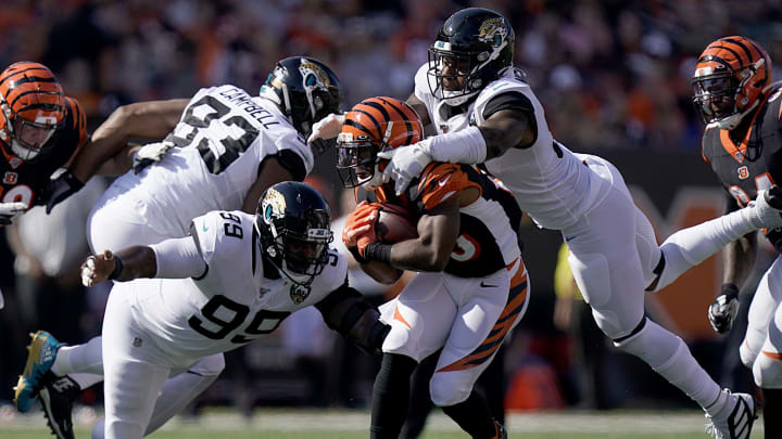 Giovani Bernard #25 of the Cincinnati Bengals, Marcell Dareus #99 and Yannick Ngakoue of the Jacksonville Jaguars (Photo by Bryan Woolston/Getty Images)