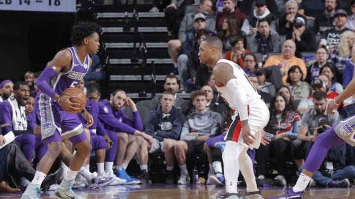 SACRAMENTO, CA - JANUARY 14: De'Aaron Fox #5 of the Sacramento Kings handles the ball against Damian Lillard #0 of the Portland Trail Blazers on January 14, 2019 at Golden 1 Center in Sacramento, California. NOTE TO USER: User expressly acknowledges and agrees that, by downloading and or using this photograph, User is consenting to the terms and conditions of the Getty Images Agreement. Mandatory Copyright Notice: Copyright 2019 NBAE (Photo by Rocky Widner/NBAE via Getty Images)