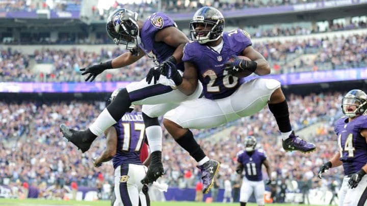 Oct 2, 2016; Baltimore, MD, USA; Baltimore Ravens running back Terrance West (28) is congratulated by running back Javorius Allen (37) after scoring a touchdown in the fourth quarter against the Oakland Raiders at M&T Bank Stadium. Mandatory Credit: Evan Habeeb-USA TODAY Sports