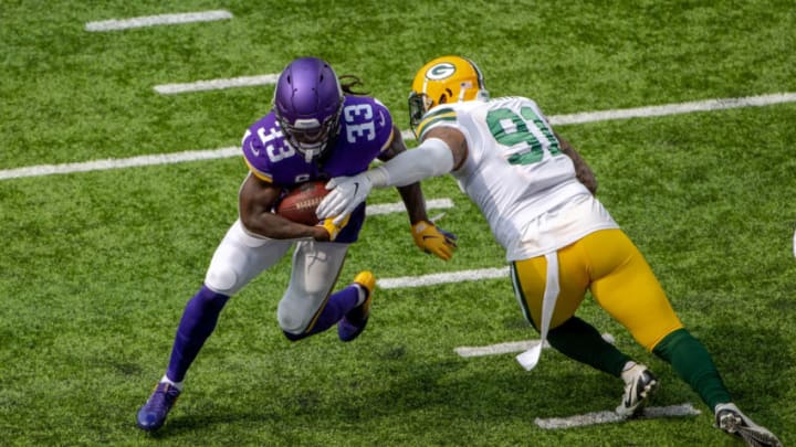 Sep 13, 2020; Minneapolis, Minnesota, USA Minnesota Vikings running back Dalvin Cook (33) rushes past Green Bay Packers outside linebacker Preston Smith (91) for a successful two point conversion in the second half at U.S. Bank Stadium. Mandatory Credit: Jesse Johnson-USA TODAY Sports