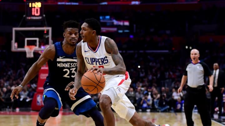 LOS ANGELES, CA - DECEMBER 06: Lou Williams #23 of the LA Clippers drives to the basket on Jimmy Butler #23 of the Minnesota Timberwolves during a 113-107 Timberwolves win at Staples Center on December 6, 2017 in Los Angeles, California. (Photo by Harry How/Getty Images)