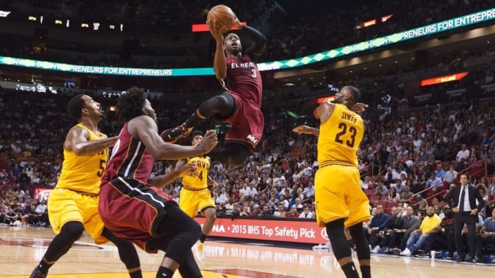 Mar 19, 2016; Miami, FL, USA; Miami Heat guard Dwyane Wade (3) drives to the basket as Cleveland Cavaliers forward LeBron James (23) looks on during the first half at American Airlines Arena. Mandatory Credit: Steve Mitchell-USA TODAY Sports