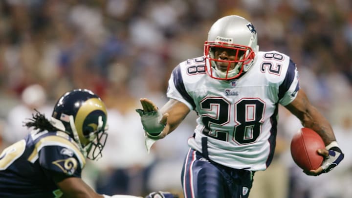 ST. LOUIS – NOVEMBER 7: Running back Corey Dillon #28 of the New England Patriots runs upfield against the St. Louis Rams on November 7, 2004 at the Edward Jones Dome in St. Louis, Missouri. The Patriots defeated the Rams 40-22. (Photo by Elsa/Getty Images)