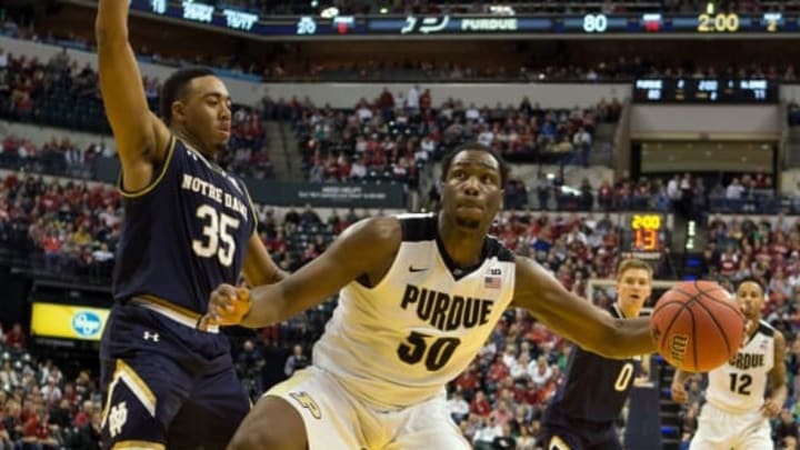Dec 17, 2016; Indianapolis, IN, USA; Purdue Boilermakers forward Caleb Swanigan (50) dribbles the ball while Notre Dame Fighting Irish forward Bonzie Colson (35) defends in the second half of the game at Bankers Life Fieldhouse. The Purdue Boilermakers beat Notre Dame Fighting Irish 86-81. Mandatory Credit: Trevor Ruszkowski-USA TODAY Sports