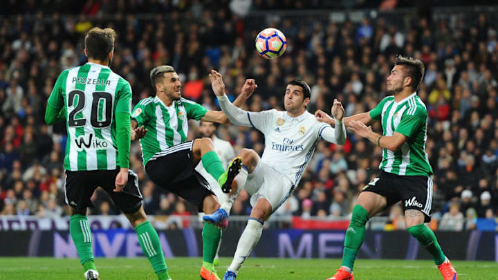 MADRID, SPAIN - MARCH 12: Alvaro Morata of Real Madrid is challenged by Dani Ceballos (L) and Tosca of Real Betis Balompie during the La Liga match between Real Madrid CF and Real Betis Balompie at Estadio Santiago Bernabeu on March 12, 2017 in Madrid, Spain. (Photo by Denis Doyle/Getty Images)