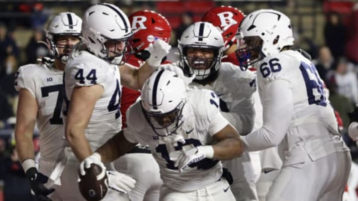 PISCATAWAY, NJ – NOVEMBER 19: Running back Kaytron Allen #13 of the Penn State Nittany Lions is congratulated by teammates Tyler Warren #44, Juice Scruggs #70 and Drew Shelton #66 after scoring a touchdown on an eight-yard run during the third quarter of a game against the Rutgers Scarlet Knights at SHI Stadium on November 19, 2022 in Piscataway, New Jersey. Penn State defeated Rutgers 55-10. (Photo by Rich Schultz/Getty Images)