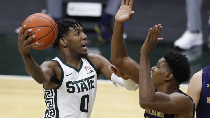 Nov 28, 2020; East Lansing, Michigan, USA; Michigan State Spartans forward Aaron Henry (0) goes to the basket as Notre Dame Fighting Irish forward Juwan Durham (11) defends during the first half at Jack Breslin Student Events Center. Mandatory Credit: Raj Mehta-USA TODAY Sports
