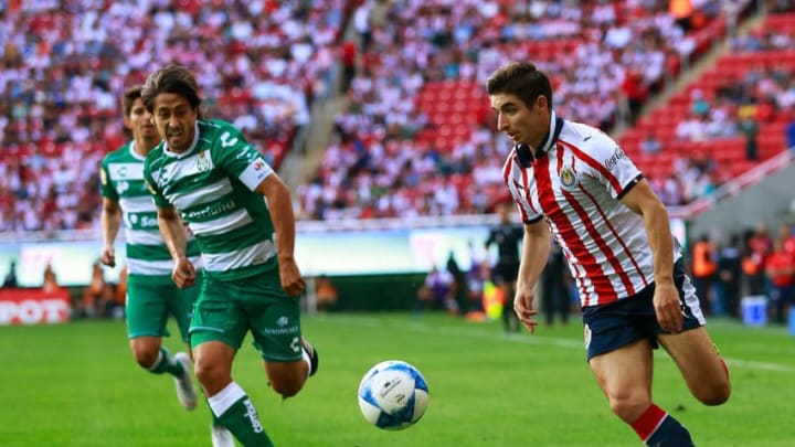 ZAPOPAN, MEXICO - AUGUST 12: Jose Abella (L) of Santos and Isaac Brizuela (R) of Chivas compete for the ball during the fourth round match between Chivas and Santos Laguna as part of the Torneo Apertura 2018 Liga MX at Akron Stadium on August 12, 2018 in Zapopan, Mexico. (Photo by Juan Mejia/Jam Media/Getty Images)