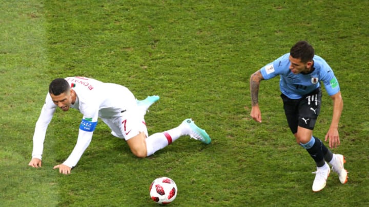 SOCHI, RUSSIA - JUNE 30: Cristiano Ronaldo of Portugal is challenged by Lucas Torreira of Uruguay during the 2018 FIFA World Cup Russia Round of 16 match between Uruguay and Portugal at Fisht Stadium on June 30, 2018 in Sochi, Russia. (Photo by Alex Livesey/Getty Images)