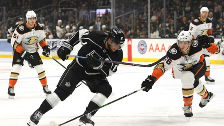 LOS ANGELES, CALIFORNIA - SEPTEMBER 23: Anze Kopitar #11 of the Los Angeles Kings puts a move around Simon Benoit #86 of the Anaheim Ducks during the second period of a preseason game against the Anaheim Ducks at Staples Center on September 23, 2019 in Los Angeles, California. (Photo by Harry How/Getty Images)