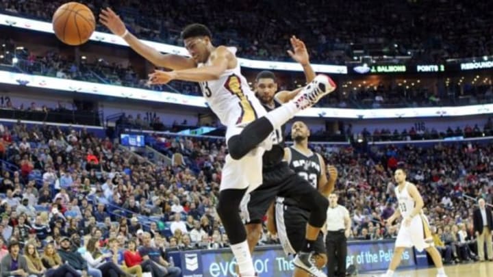 Dec 26, 2014; New Orleans, LA, USA; New Orleans Pelicans forward Anthony Davis (23) is fouled by San Antonio Spurs forward Tim Duncan (21) in the second half at the Smoothie King Center. New Orleans defeated San Antonio 97-90. Mandatory Credit: Crystal LoGiudice-USA TODAY Sports